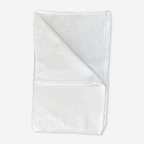 White mop folded on a white background, used for hospitality services.