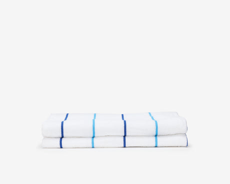 Folded pool towel, white with small dark blue and light blue stripes.