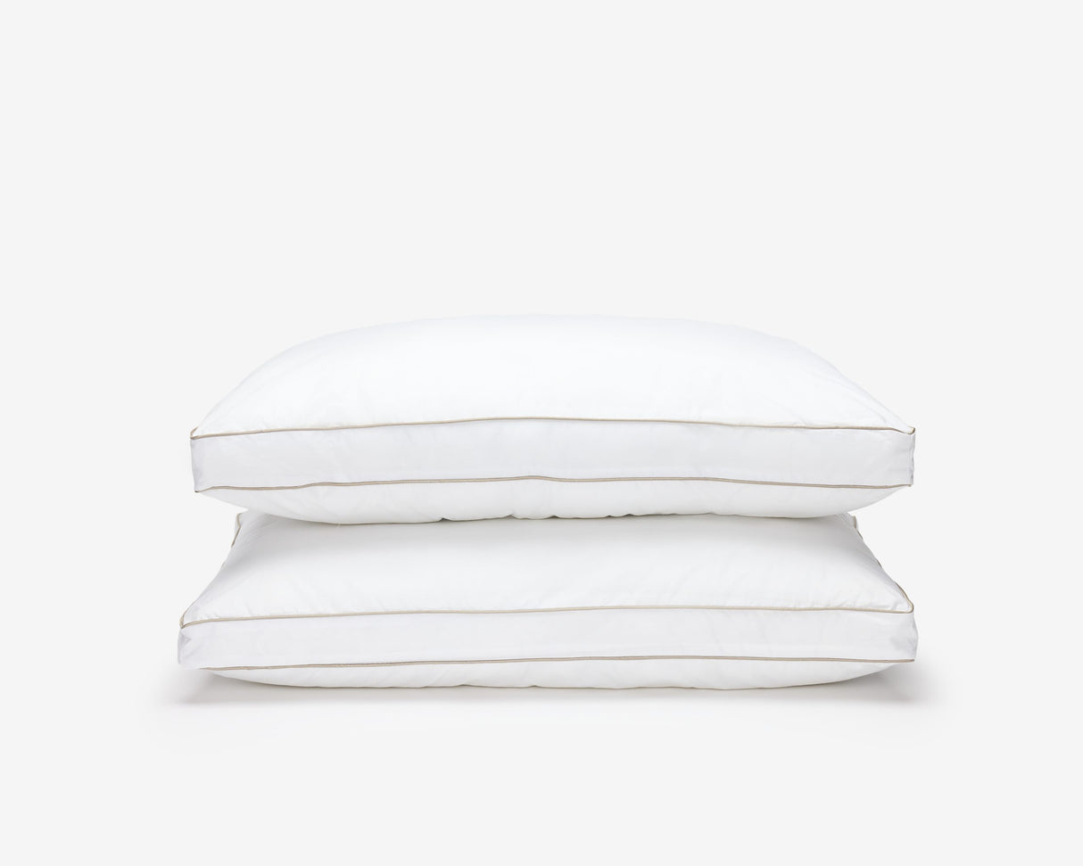Two white O'zenith pillow, one on top of the others.