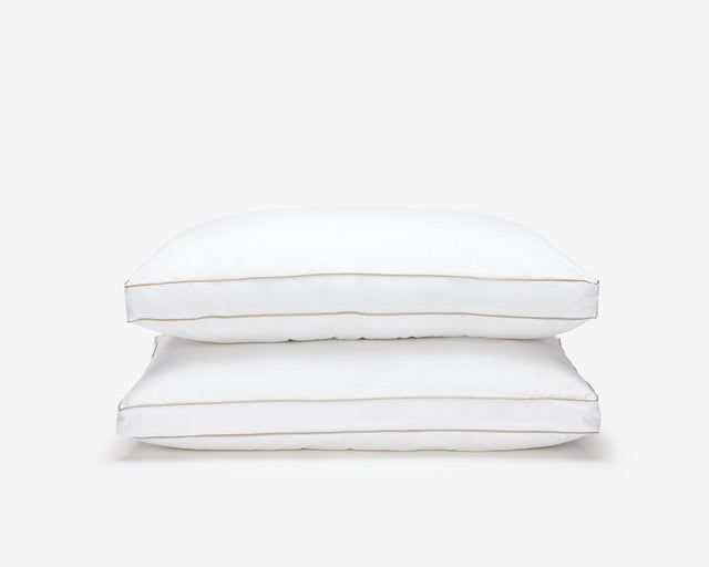 Two white O'zenith pillow, one on top of the others.