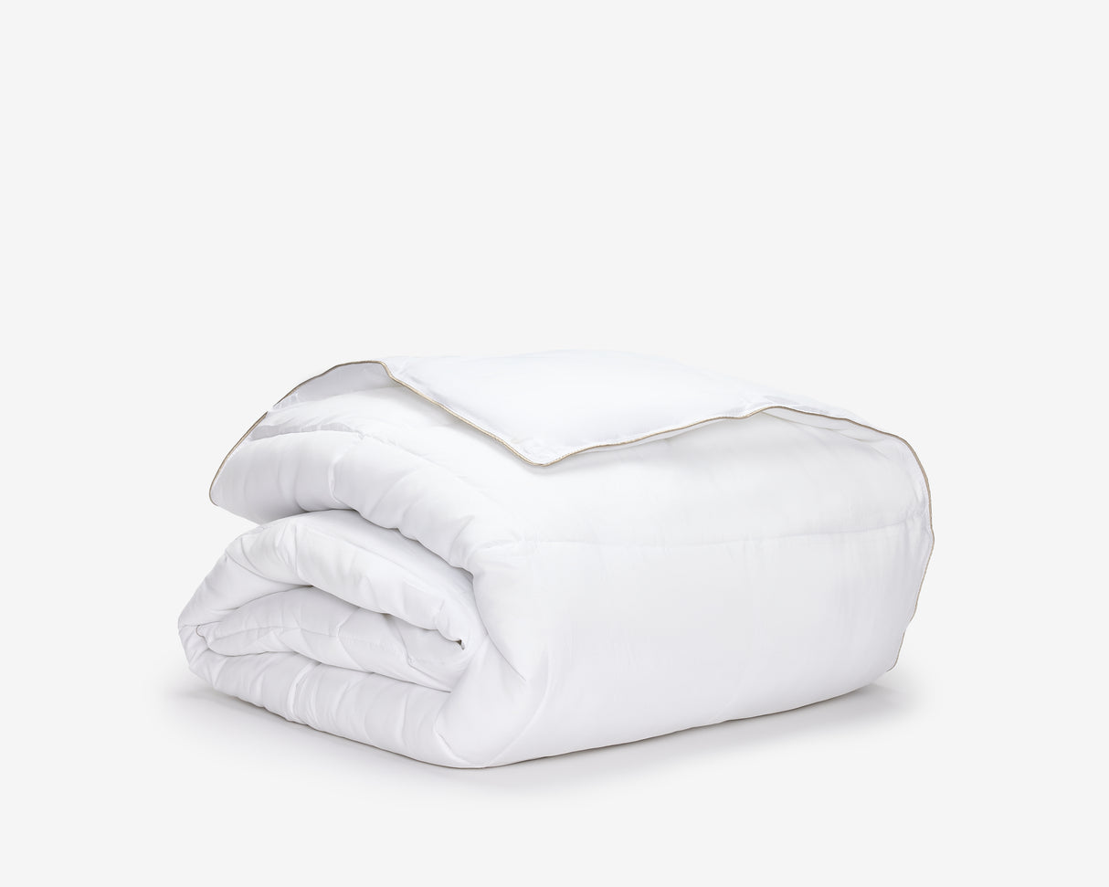 White hotel bed duvet folded.