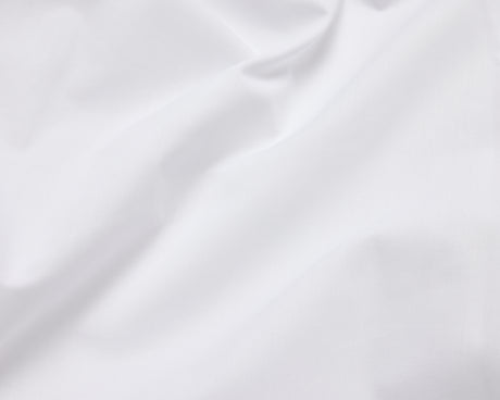 Close up picture on white hotel bed sheets.