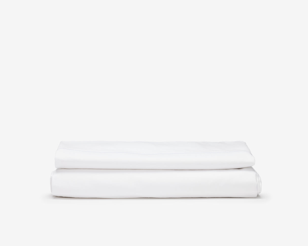 White hotel bed sheets folded.