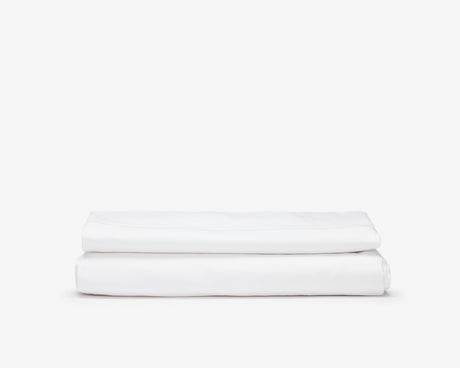 White hotel bed sheets folded.