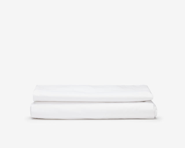 White hotel bed sheets folded.